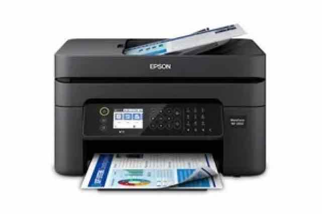 Black Epson wireless all-in-one printer printing a colour document, shown front-facing on a white background with a page loaded in the scanner bed.